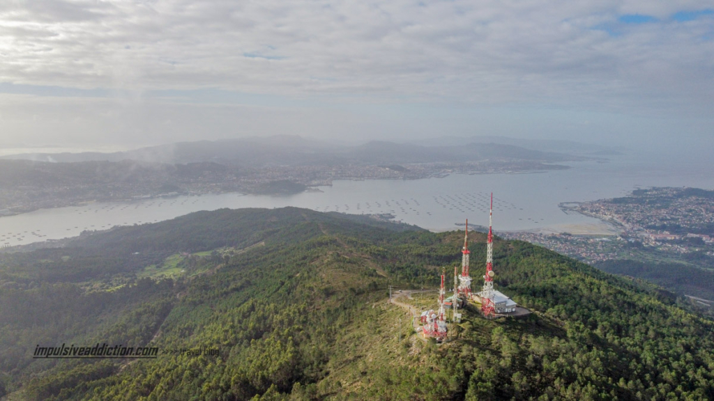 Foto de drone do Faro Domaio e da Ria de Vigo. Miradouro frente à central de telecomunicações