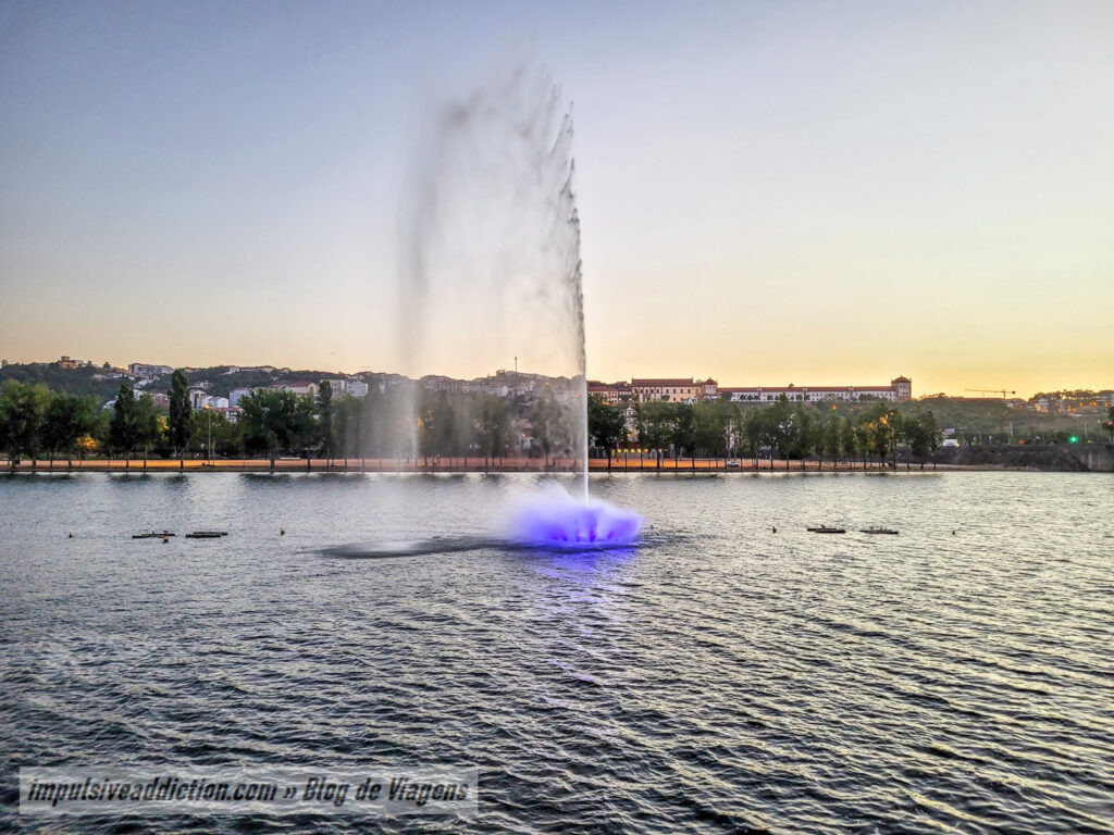Luminous Fountain on Mondego River at dusk